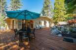 Enjoy outdoor living on this expansive wooden deck, perfect for entertaining or relaxing.