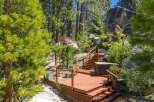 Experience outdoor living at its finest on this expansive wooden deck, complete with a relaxing hot tub and comfortable seating areas.
