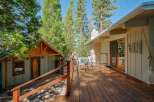 Enjoy the serene mountain lifestyle with this charming property featuring a spacious wooden deck perfect for outdoor relaxation and entertaining.