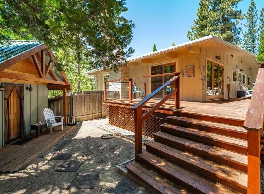 Enjoy outdoor living with this expansive wooden deck, perfect for entertaining or relaxing in the fresh air.