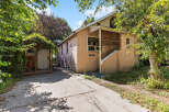 Charming home with a stucco exterior and a covered front porch, perfect for enjoying the outdoors.