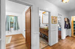 Step into this charming home featuring a bright bedroom with a large window and light blue curtains, perfect for natural light.