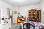 This charming kitchen features a white stove with a patterned towel hanging from the oven door.