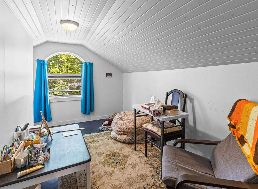 Discover a cozy attic room perfect for a home office or creative space.