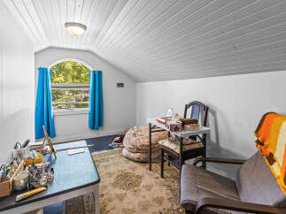 Discover a cozy attic room perfect for a home office or creative space.
