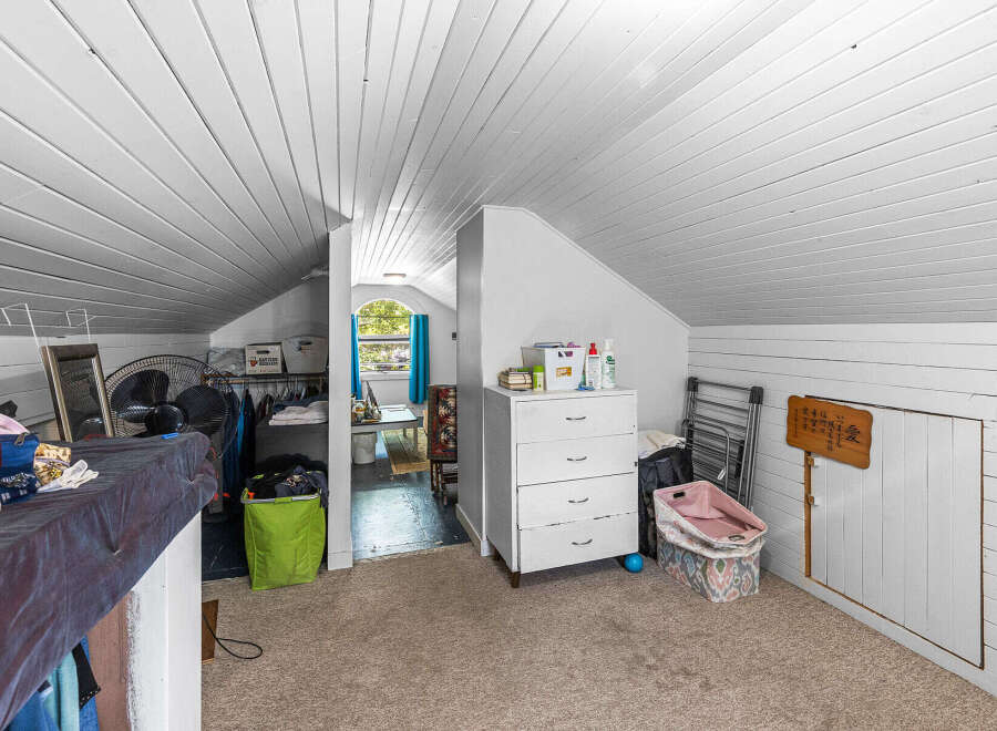 Discover versatile living in this charming attic space, perfect for a home office, playroom, or extra storage.
