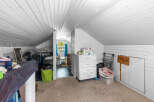 Discover versatile living in this charming attic space, perfect for a home office, playroom, or extra storage.