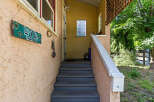 Welcome guests with this charming entryway featuring a decorative house number sign and a welcoming porch.