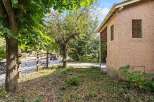 Discover this charming property featuring a rustic wooden fence and lush greenery, perfect for outdoor enjoyment.