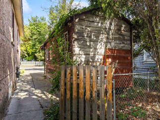 Discover the potential of this property with its charming rustic shed, perfect for storage or a workshop.