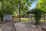 Enjoy outdoor living in this charming backyard featuring a spacious wooden deck perfect for entertaining.
