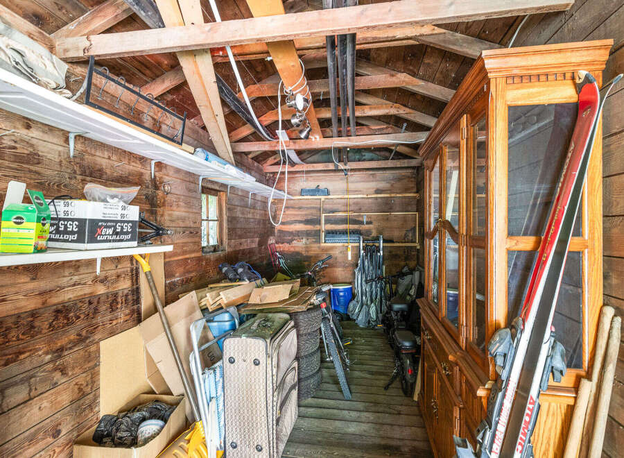 Discover ample storage solutions in this rustic shed, perfect for organizing outdoor gear and equipment.