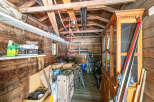 Discover ample storage solutions in this rustic shed, perfect for organizing outdoor gear and equipment.