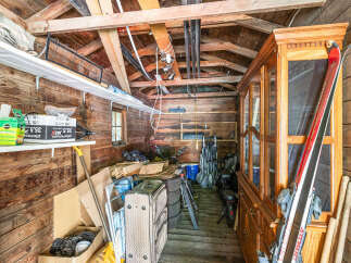 Discover ample storage solutions in this rustic shed, perfect for organizing outdoor gear and equipment.