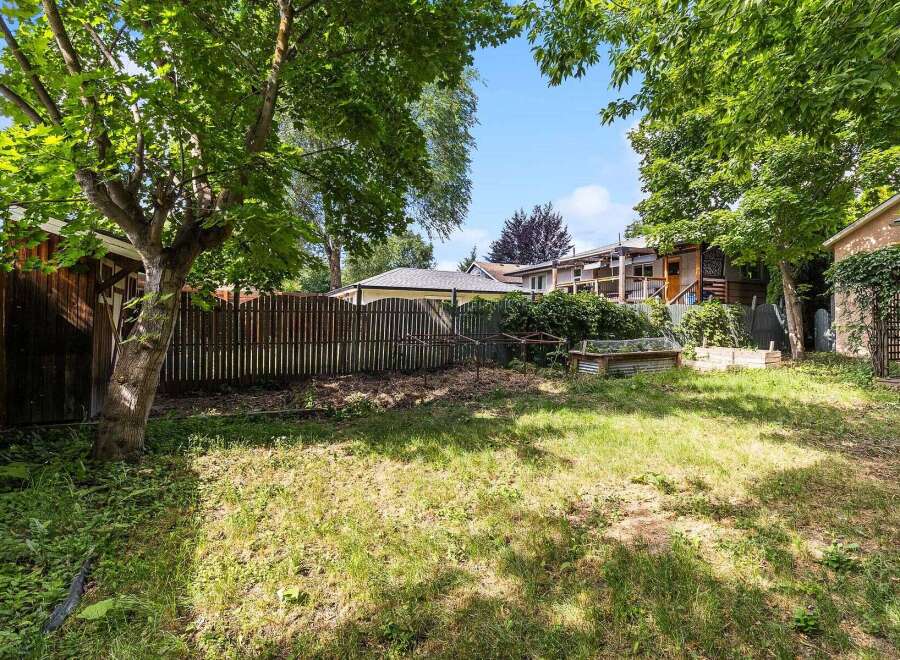 Discover this charming backyard oasis, perfect for gardening enthusiasts and outdoor relaxation.