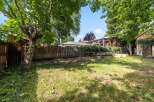 Discover this charming backyard oasis, perfect for gardening enthusiasts and outdoor relaxation.
