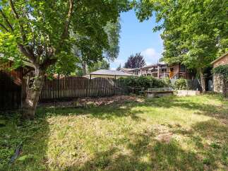 Discover this charming backyard oasis, perfect for gardening enthusiasts and outdoor relaxation.