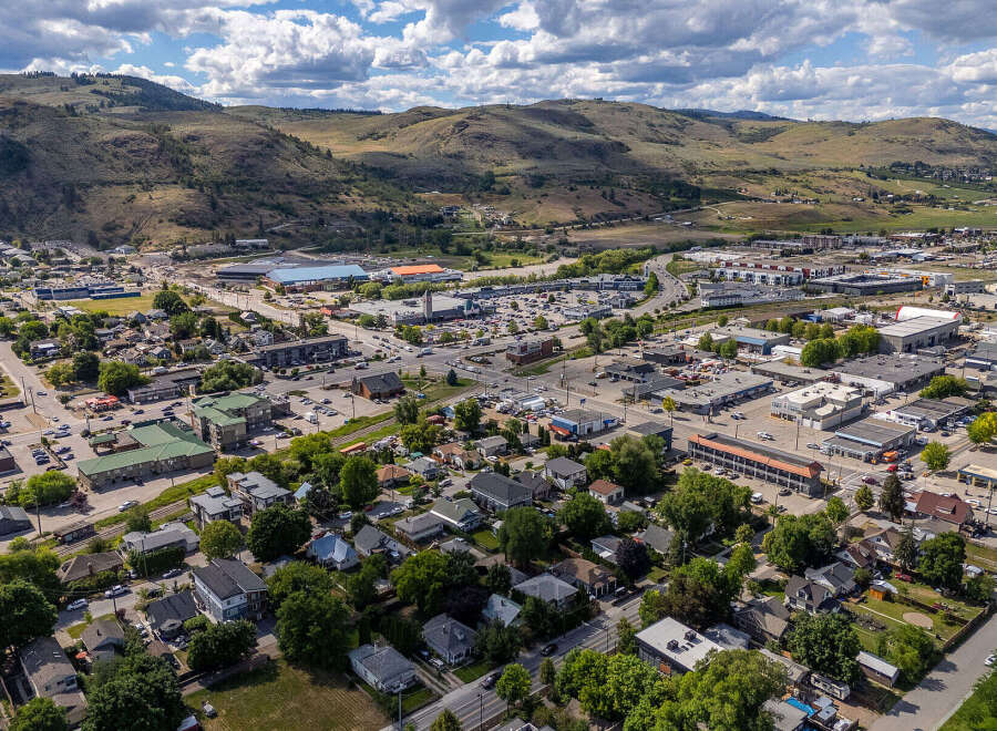 Discover this expansive aerial view showcasing a vibrant community nestled against rolling hills.