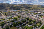 Discover this expansive aerial view showcasing a vibrant community nestled against rolling hills.