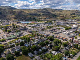 Discover this expansive aerial view showcasing a vibrant community nestled against rolling hills.