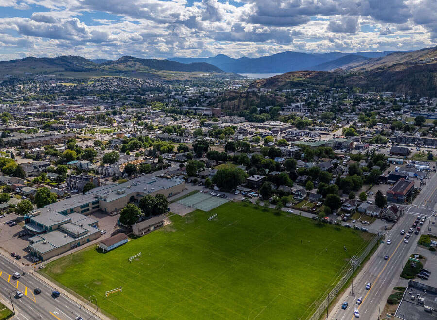 Discover this prime real estate opportunity featuring a spacious school building adjacent to a large, well-maintained sports field with soccer goals and tennis courts.