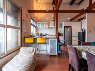 Experience modern living in this spacious open-concept apartment featuring a sleek kitchen with ample cabinet space and a breakfast bar perfect for casual dining.