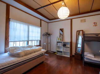This cozy bedroom features a comfortable single bed and a bunk bed, perfect for families or accommodating guests.