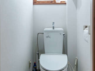 This compact bathroom features a modern white toilet with a built-in bidet function, perfect for a small space.