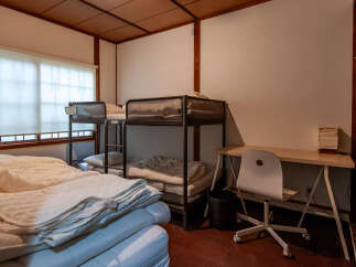 This cozy room features a space-saving bunk bed, perfect for maximizing sleeping arrangements.