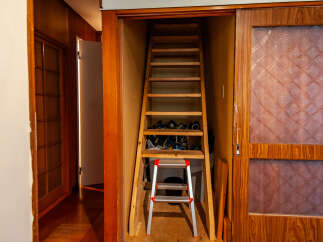 Discover this charming home featuring a unique loft access with a wooden ladder, perfect for storage or a cozy reading nook.