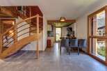 Experience modern alpine living in this beautifully appointed apartment, featuring a stunning wooden spiral staircase leading to the upper levels.