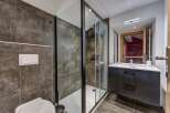 Experience modern luxury in this stunning bathroom featuring a spacious glass-enclosed shower with sleek black trim.