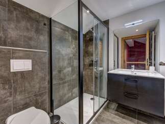 Experience modern luxury in this stunning bathroom featuring a spacious glass-enclosed shower with sleek black trim.