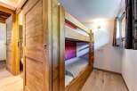 This charming room features a sturdy wooden bunk bed, perfect for accommodating guests or family.