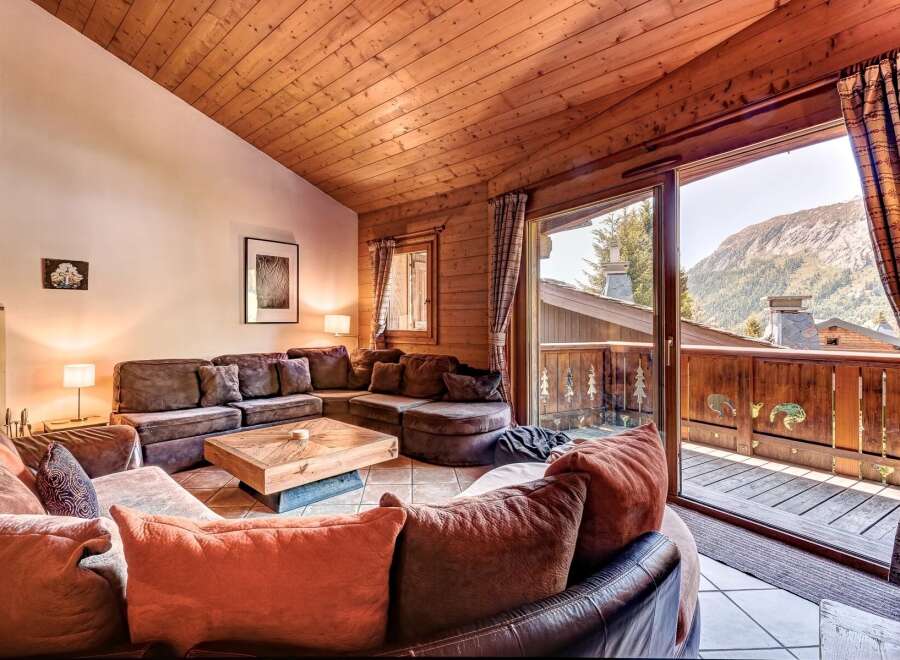 Experience cozy mountain living in this charming living room, featuring a large sectional sofa perfect for gathering.