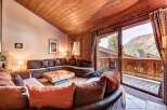 Experience cozy mountain living in this charming living room, featuring a large sectional sofa perfect for gathering.