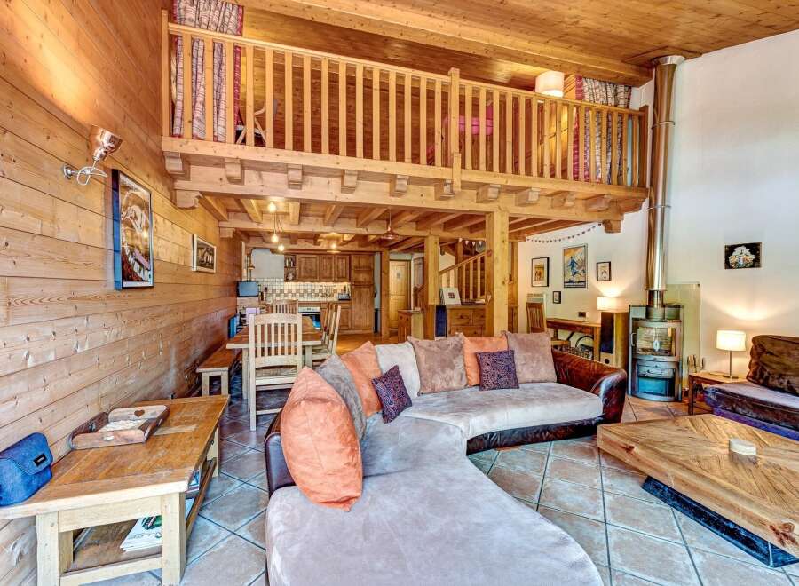 Experience rustic charm in this stunning chalet featuring a spacious open-plan living area with a cozy fireplace and a charming loft.