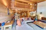 Experience rustic charm in this stunning chalet featuring a spacious open-plan living area with a cozy fireplace and a charming loft.
