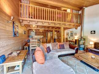 Experience rustic charm in this stunning chalet featuring a spacious open-plan living area with a cozy fireplace and a charming loft.