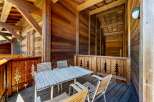 Enjoy your morning coffee or evening drinks on this charming wooden balcony, complete with a rustic table and chairs.