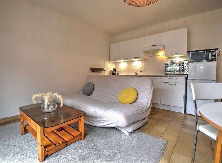 Discover this charming studio apartment featuring a compact kitchen equipped with modern appliances and ample cabinet space.