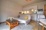 Discover this charming studio apartment featuring a compact kitchen equipped with modern appliances and ample cabinet space.