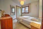 Discover this charming bedroom featuring a comfortable single bed dressed in crisp white linens.