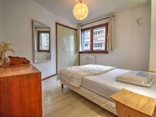 Discover this charming bedroom featuring a comfortable single bed dressed in crisp white linens.