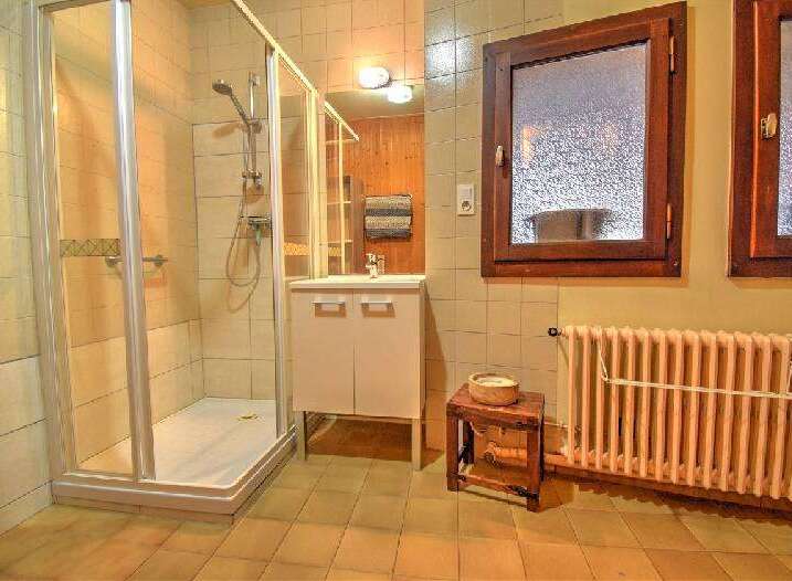 This charming bathroom features a spacious glass-enclosed shower, perfect for a refreshing start to your day.
