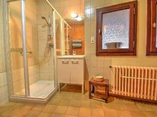 This charming bathroom features a spacious glass-enclosed shower, perfect for a refreshing start to your day.