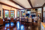 Experience rustic elegance in this stunning mountain home, featuring a spacious dining area with panoramic views and a grand living room centered around a magnificent stone fireplace.