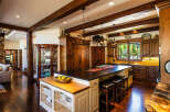 Experience rustic luxury in this stunning mountain kitchen, featuring rich wooden cabinetry, exposed beams, and a spacious island perfect for entertaining.