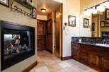 Experience luxury and comfort in this stunning master bathroom, featuring a cozy gas fireplace perfect for relaxing evenings.