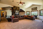 Experience breathtaking mountain views from this spacious living room, featuring a large sectional sofa perfect for gatherings.